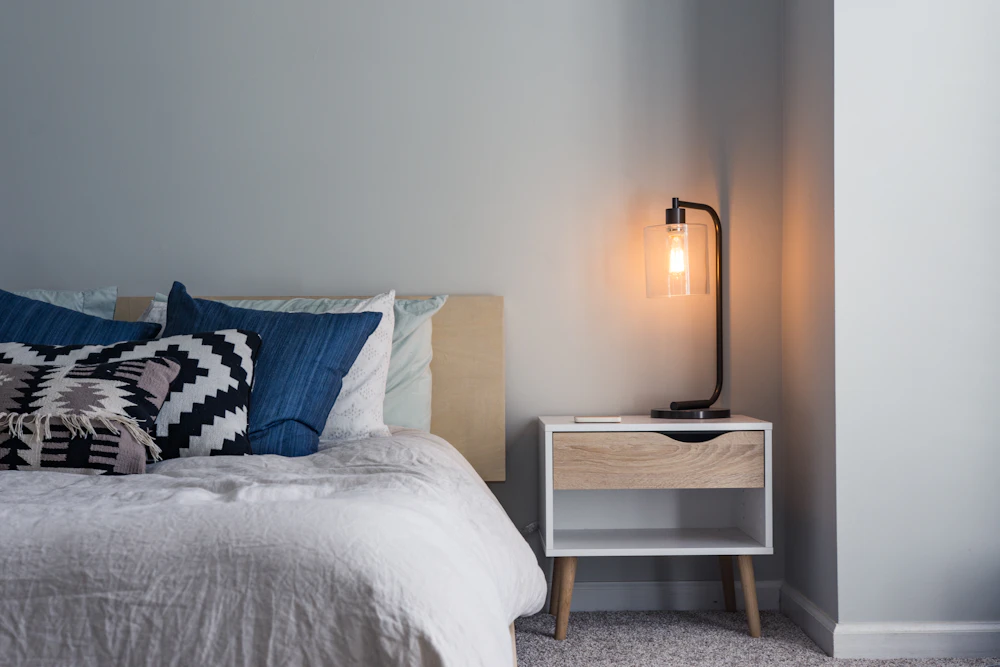 Bedroom interior detail with bedside lamp and nightstand