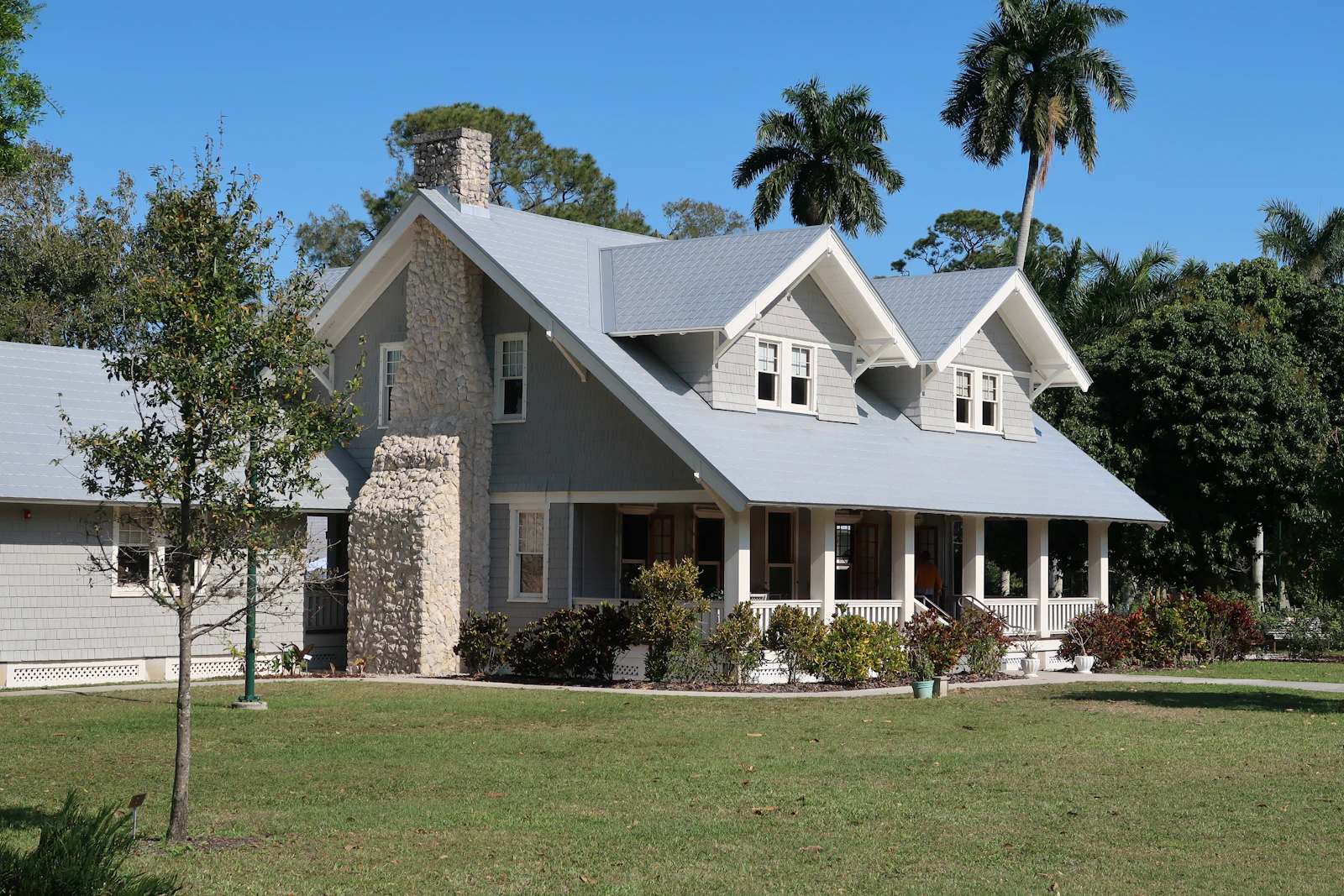 Traditional villa exterior with covered porch and garden