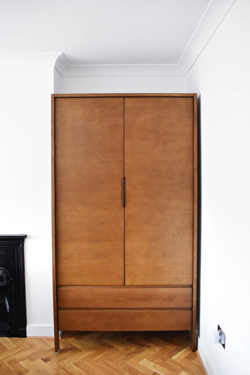 Freestanding wardrobe in a warm wood veneer finish